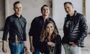 Zespół muzyczny gotowy, by zabierz mnie do gwiazd. Wokalistka z gitarą, perkusista z pałeczkami i dwaj gitarzyści.