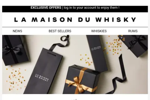Eleganckie czarne opakowania z logo "La Maison du Whisky" i złotymi wstążkami, otoczone konfetti. Idealne na prezent dla miłośnika whisky.